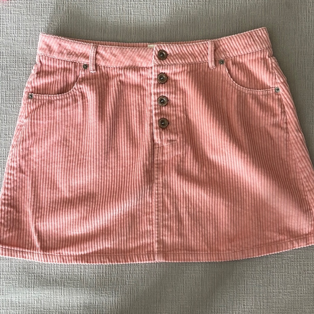 Pink corduroy miniskirt with four front buttons